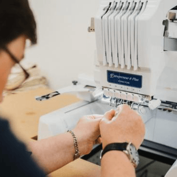 Jessica threading the embroidery machine ready for logo stitching on our mattresses