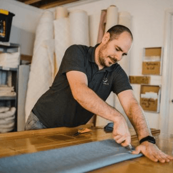 Ian measuring and cutting Bray Blue Wool Flax fabric for a Pocket Sprung Futon Mattress