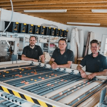 The chaps taking a break before tufting a mattress in the press
